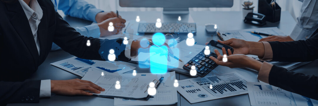 A professional team collaborates with digital communication icons in an office environment, illustrating teamwork and modern corporate strategies. Trope