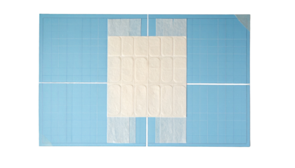 Overhead shot of a blue cutting mat with a white paper sheet in the center