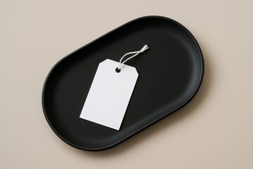 Fototapeta premium Blank white tag with string on black ceramic tray for branding or product mockup on neutral background, minimal and elegant template design. Ai generative