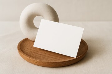 Blank business card mockup standing on wooden tray with modern ceramic decor for branding and copyspace template on neutral fabric background. Ai generative