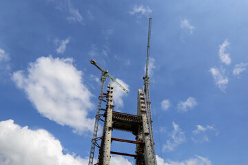 Construction of High-Rise Structural Framework of Cable Stayed Tower Bridge with Tower Cranes