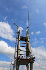 Construction of High-Rise Structural Framework of Cable Stayed Tower Bridge with Tower Cranes