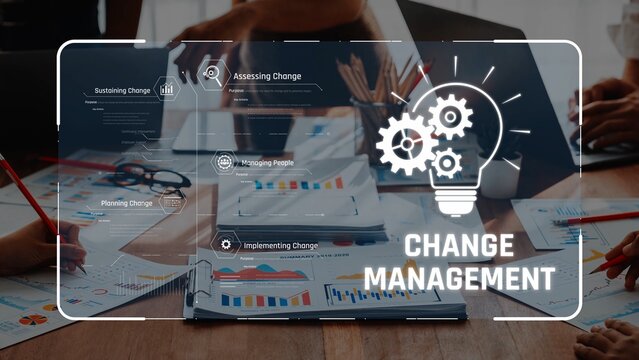 A dynamic business meeting focused on change management, featuring collaborative teamwork, laptops, and data visualization, ideal for project planning and strategic implementation. Raster