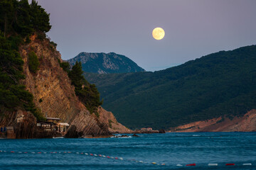 beautiful sunset over Adriatic sea, rocky coast and moon, beautiful landscape of Montenegro