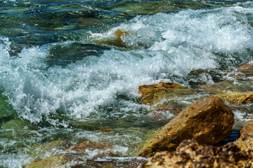 beautiful summer landscape of rocky sea coast, rocks on the edge of cliff, view onto water and waves, bright sunny day
