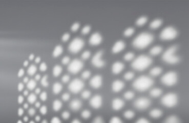 Blurred gray background with subtle shadow patterns of Islamic windows, empty studio space. Textured walls.