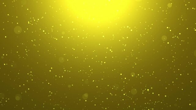 Golden yellow glowing bokeh background with sparkling particles and shining light for luxury festive design.