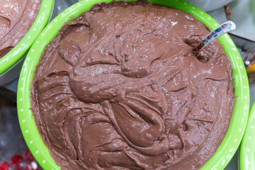 Large green basin filled with smooth, purple-brown fermented shrimp paste, a pungent and essential ingredient in traditional Hue cuisine.