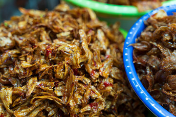 Crispy caramelized dried anchovies seasoned with spicy chili, a savory traditional Hue specialty often served with white rice.