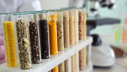 Test tubes filled with various herbs and spices arranged on a lab bench during a research activity concept