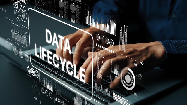 Hands Typing on Laptop with Graphs and Data Lifecycle Infographic Overlay in Modern Office Setting. Asymptotic smart data analytic.