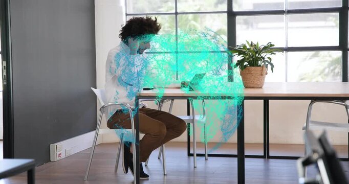 Mid adult man typing on laptop activating teal globe pulsing enveloping torso for tech demo