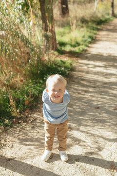 Happy toddler boy smiling enjoying nature outdoors