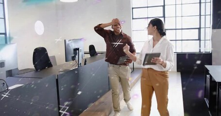 Coworkers walking office, woman showing tablet starting sparkles while man checking business charts - Powered by Adobe
