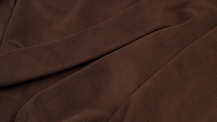 Fleece fabric brown top view. Texture of textile fleece bedspread.