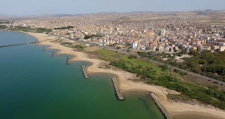 Aerial view of the waterfront of the city of Gela, located in the province of Caltanissetta, Sicily, Italy. It is a small town overlooking the Mediterranean Sea. It has a long sandy beach.