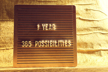 Obraz premium Board with the text 1 year 365 possibilities. Motivation and inspiration concept