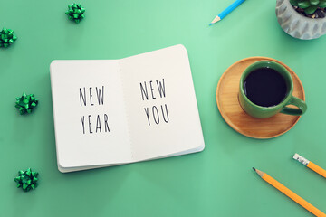 Obraz premium Top view image of notebook with motivation text. Concept of new possibilities, and inspiration