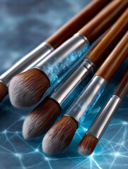 Paintbrushes with wooden handles on a textured surface.