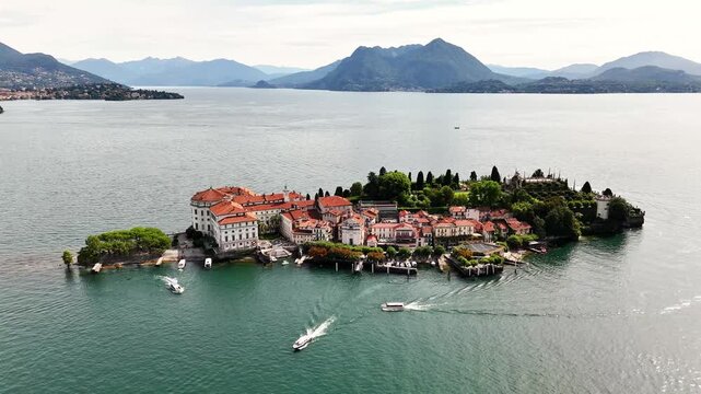 Drone establishing shot of Isola Bella, Lake Maggiore, Italy, Highlights Baroque Palazzo Borromeo, tiered gardens, and fishing village against the Alps backdrop, Stresa, VB, Piedmont region.