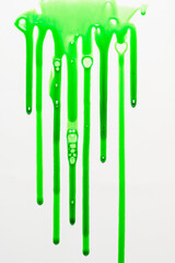 Fresh green liquid spill or splat with bubbles on a white background