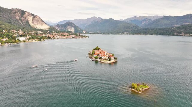 Aerial view showing Isola Bella with its baroque palace , also showing the surrounding lake, mountains, and coastal Italian towns in the distance, Stresa, VB, Piedmont, northern western Italy