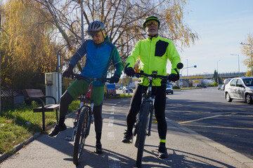 An old man who is passionate about cycling rides his bike with his son, enjoying a beautiful autumn...