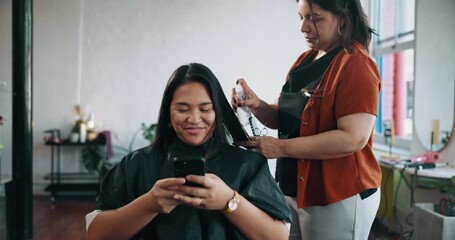 Woman, hairdresser and spray at salon, phone or happy customer with chat, grooming or service at small business. People, client and smartphone on app, contact and social media for hairstyle at parlor