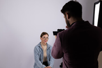 A photographer is conducting a photojournalistic interview with a subject 