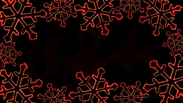 Merry Christmas xmas winter holiday celebration greeting card template - Abstract frame made of led snowflakes, ice crystals fairy lights ornament, isolated on black background texture