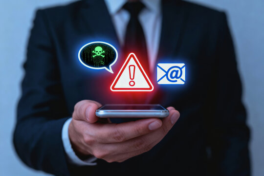 Serious businessman holding mobile phone with scam detection system showing security alert for phishing message
