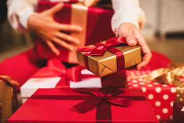 Wrapped Christmas gift box in hand of woman 