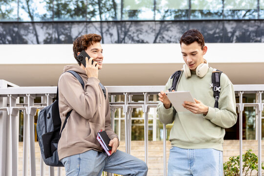 University students staying connected with phone and tablet after class