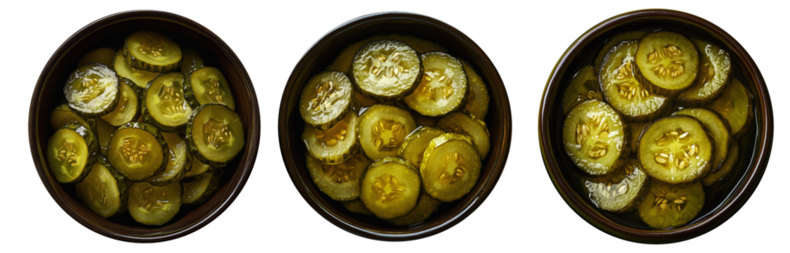 Sliced pickles in dark ceramic dish, isolated on white transparent background, concept of snack.