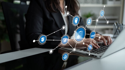 A business professional engaged with a laptop in a modern office, featuring a digital interface with icons that symbolize networking and data management processes. Tessel
