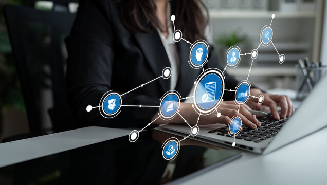 A business professional engaged with a laptop in a modern office, featuring a digital interface with icons that symbolize networking and data management processes. Tessel