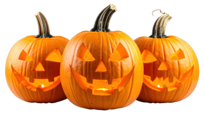 Three grinning, carved, illuminated pumpkins on a black background