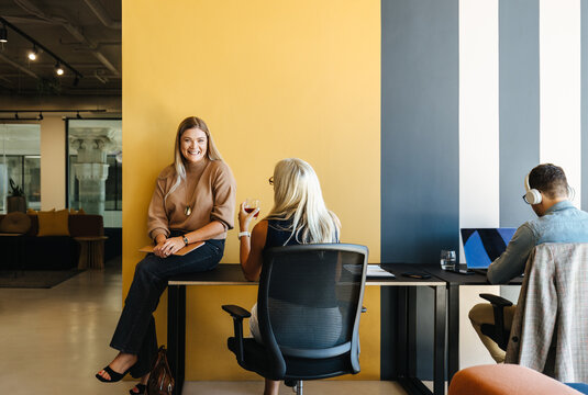Team discussing ideas in a modern open workspace with stylish decor - Powered by Adobe