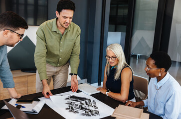 Team discussing architectural designs in a modern office space