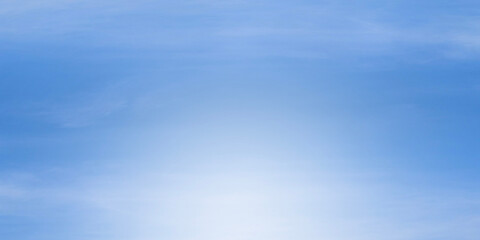 Bright, clear blue sky with soft white glow centered at the bottom suggesting sunny day or an...