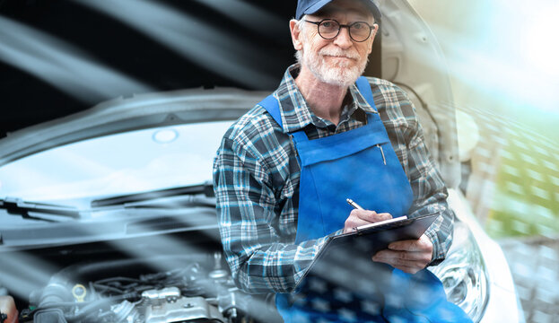 Car mechanic checking a car engine; light effect