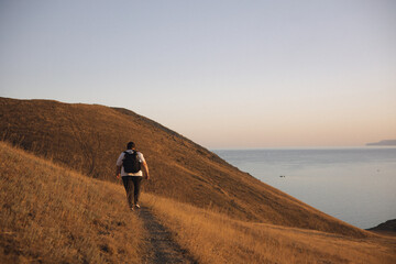 An overweight woman walks in the mountains, actively spends her weekend, active life, active lifestyle, excess weight.
