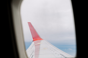 Airplane wing and sky view from aircraft window during flight