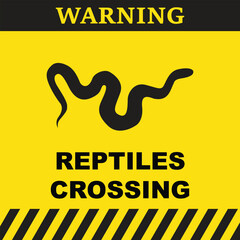 Warning symbol with silhouette of a snake and the text reptiles crossing