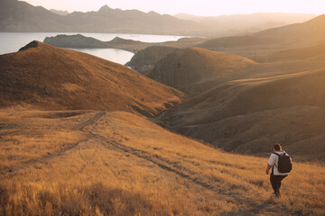 An overweight woman walks in the mountains, actively spends her weekend, active life, active lifestyle, excess weight.