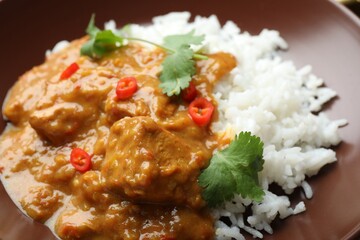 Chicken tikka masala with rice in bowl, closeup