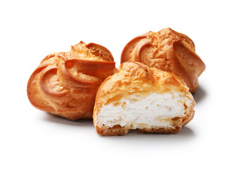 Delicious profiteroles with whipped cream isolated on white