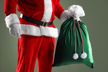 Santa Claus with sack on grey background, closeup. Merry Christmas and Happy New Year