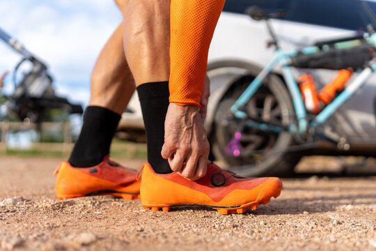 Close up cyclist preparing shoe for outdoor adventure