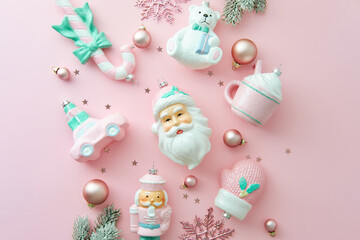 Fat lay pastel pink and mint Christmas ornaments on a bright pink background. Cute, shabby chic Xmas style.